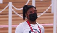Simone Biles of the United States wearing a protective face mask looks on. Reuters/Mike Blake
