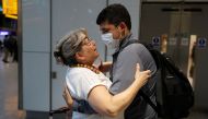 Karen Tyler embraces her son Jonathan who arrived from the U.S., at the International arrivals area of Terminal 5 in London's Heathrow Airport, Britain, August 2, 2021. Reuters/Peter Nicholls
