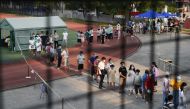 Residents line up at a nucleic acid testing site during a citywide mass testing following new cases of the coronavirus disease (COVID-19) in Wuhan, Hubei province, China, August 3, 2021. Picture taken August 3, 2021. REUTERS/Stringer 