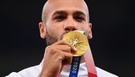 Gold medallist, Lamont Marcell Jacobs of Italy poses on the podium REUTERS/Dylan Martinez/File Photo