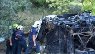 First responders work at the crash site, after a bus rolled over on the M7 motorway, killing at least eight people, in the early hours of Sunday near Szabadbattyan, Hungary August 15, 2021. Zoltan Mihadak/Pool via REUTERS