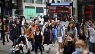 People walk through Oxford Circus, amid the coronavirus disease (COVID-19) outbreak, in London, Britain, July 26, 2021. REUTERS/Henry Nicholls/File Photo
