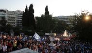 People take part in a protest against coronavirus disease (COVID-19) vaccinations outside the parliament building, in Athens, Greece, August 29, 2021. REUTERS/Costas Baltas
