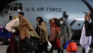 People who have been evacuated from Afghanistan arrive at Pristina International Airport in Pristina, Kosovo August 29, 2021, after Taliban insurgents entered Afghanistan's capital Kabul. REUTERS/Laura Hasani