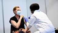 Danish Prime Minister Mette Frederiksen is vaccinated against COVID-19 by vaccinator Huda Beklar in Oksnehallen in Copenhagen, Denmark June 4, 2021. Philip Davali/Ritzau Scanpix/via REUTERS