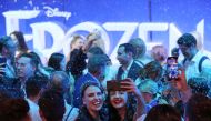 People take photos during the opening night of 