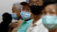People wait at an observation area after their vaccination at a coronavirus disease (COVID-19) vaccination center in Singapore March 8, 2021. REUTERS/Edgar Su/File Photo