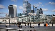 The City of London financial district can be seen as people walk along the south side of the River Thames, amid the coronavirus disease (COVID-19) outbreak in London, Britain, March 19, 2021. Reuters/Henry Nicholls