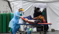 A health worker wearing personal protective equipment (PPE) as protection against the coronarivus disease (COVID-19) transports a suspected COVID-19 patient, at Sta. Ana Hospital, in Manila, Philippines, September 8, 2021. REUTERS/Lisa Marie David/File Ph