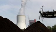 FILE PHOTO: A cooling tower from the Turow coal-fired power plant is seen near the Turow open-pit coal mine operated by the company PGE in Bogatynia, Poland, June 15, 2021. Picture taken June 15, 2021. REUTERS/David W Cerny/File Photo
