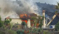 A house burns due to lava following the eruption of a volcano in the Cumbre Vieja national park, in the residential area of Los Campitos at Los Llanos de Aridane, on the Canary Island of La Palma, Spain, September 20, 2021. REUTERS/Borja Suarez
