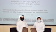 QU President Dr. Hassan Rashid Al Derham (right) and Secretary-General of QRDI Council Eng. Omar Ali Al Ansari at the MoU signing event held at Qatar University yesterday. 