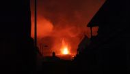 Lava and smoke rise following the eruption of a volcano in Los Llanos de Aridane, on the Canary Island of La Palma, Spain, September 22, 2021. REUTERS/Nacho Doce