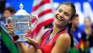 Emma Raducanu of Great Britain celebrates with the championship trophy after her match against Leylah Fernandez of Canada in the women's singles final on day thirteen of the 2021 U.S. Open tennis tournament at USTA Billie Jean King National Tennis Center.