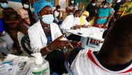 Aminata Laye Diagne, a nurse gives a dose of coronavirus disease (COVID-19) vaccine to a man at Philippe Senghor Hospital in Dakar, amid a surge of coronavirus disease (COVID-19) cases in Senegal July 28, 2021. REUTERS/Zohra Bensemra/File Photo