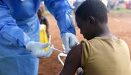 FILE PHOTO: A Congolese health worker administers Ebola vaccine to a boy who had contact with an Ebola sufferer in the village of Mangina in North Kivu province of the Democratic Republic of Congo, August 18, 2018. REUTERS/Olivia Acland