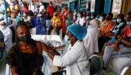 Aminata Laye Diagne, a nurse gives a dose of coronavirus disease (COVID-19) vaccine to a woman at Philippe Senghor Hospital in Dakar, amid a surge of coronavirus disease (COVID-19) cases in Senegal July 28, 2021. .REUTERS/Zohra Bensemra/File Photo/File Ph