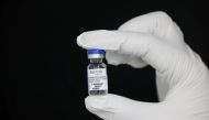 An employee holds a vial containing Sputnik vaccine at a factory of Hankook Korus Pharm, in Chuncheon, South Korea September 10, 2021. Picture taken September 10, 2021. REUTERS/Heo Ran