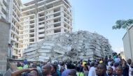 People gather at the site of a collapsed 21-story building in Ikoyi, Lagos, Nigeria, November 1, 2021. REUTERS/Temilade Adelaja

