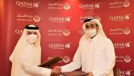 Minister of Labour H E Dr. Ali bin Smaikh Al Marri and Qatar Airways Group Chief Executive H E Akbar Al Baker exchanging documents after signing the agreement.