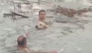 Spanish police rescue a dog from a frozen reservoir in the municipality of Canfranc in Spain, in this still image taken from a handout video obtained by Reuters on December 8, 2021. Spanish Police/Handout via REUTERS