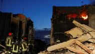 Members of a rescue team work at the scene where a four-storey building collapsed following a gas explosion, in Ravanusa, Italy, December 12, 2021. REUTERS/Antonio Parrinello