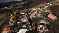 Aerial view of a group of houses surrounded by the lava of the Cumbre Vieja volcano in an exclusion zone in Las Manchas, on the Canary Island of La Palma, Spain, December 17, 2021. Picture taken with a drone. REUTERS/Borja Suarez/File Photo