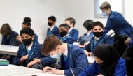 Year 9 students wear protective face masks as they take part in lessons on the first day back at school, as the coronavirus disease (COVID-19) lockdown begins to ease at Harris Academy Sutton, south London, Britain, March 8, 2021. REUTERS/Toby Melville/File Photo