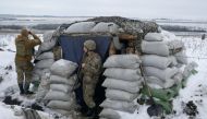 Service members of the Ukrainian armed forces stand guard at combat positions on the line of separation from Russian-backed rebels outside the settlement of Krymske in the Luhansk region, Ukraine, January 4, 2022. REUTERS/Maksim Levin