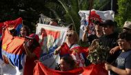 Supporters of Serbian tennis player Novak Djokovic rally outside the Park Hotel, where the star athlete is believed to be held while he stays in Australia, in Melbourne, Australia, January 6, 2022. Reuters/Loren Elliott