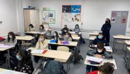FILE PHOTO: Schoolchildren, wearing protective face masks, work in a classroom at the College Jean Renoir Middle School in Boulogne-Billancourt, near Paris, France, January 7, 2022. REUTERS/Yiming Woo/File Photo
