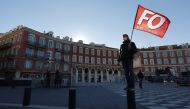 A man holds a flag of French Force Ouvriere (FO) labour union during a demonstration by French teachers in Nice. Reuters/Eric Gaillard
