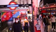 People exit Piccadilly Circus underground station, amid the coronavirus disease (COVID-19) outbreak, in central London, Britain, January 6, 2022. REUTERS/Henry Nicholls

