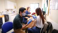 A person receives a dose of the Pfizer BioNTech vaccine, at vaccination centre for young people and students at the Hunter Street Health Centre, amid the coronavirus disease (COVID-19) outbreak, in London, Britain, June 5, 2021. REUTERS/Henry Nicholls

