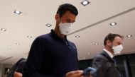 Serbian tennis player Novak Djokovic walks in Melbourne Airport before boarding a flight, after the Federal Court upheld a government decision to cancel his visa to play in the Australian Open, in Melbourne, Australia, January 16, 2022. REUTERS/Loren Elliott