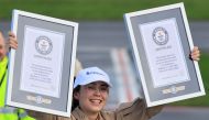 Belgian-British pilot Zara Rutherford, 19, holds her Guinness World Record certificates following her landing at Kortrijk-Wevelgem Airport, after a round-the-world trip in a light aircraft, becoming the youngest female pilot to circle the planet alone, in Wevelgem, Belgium, January 20, 2022. REUTERS/Pascal Rossignol
