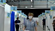 FILE PHOTO: A nurse Frances Whyte brings a tray of Moderna coronavirus disease (COVID-19) vaccine boosters to a bay for a person to be vaccinated at the RDS (Royal Dublin Society) vaccination centre in Dublin, Ireland, January 12, 2022. REUTERS/Clodagh Kilcoyne/File Photo
