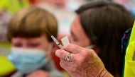 A child is seen near a syringe containing a dose of the Pfizer-BioNTech coronavirus disease (COVID-19) vaccine at Smoketown Family Wellness Center in Louisville, Kentucky, U.S., November 8, 2021. REUTERS/Jon Cherry/File Photo