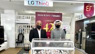 Ranjith Abraham (left), Head of Retail at Jumbo Electronics, along with a representative of the Ministry of Commerce and Industry during the raffle draw. 