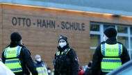Police walks in front of a school in Hamburg Jenfeld, Germany, February 1, 2022, during a major police operation after an armed youth is believed to have entered the building earlier today. REUTERS/Cathrin Mueller

