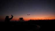 A mother and her daughter wave to an airplane from a viewpoint as it approaches to land at Josep Tarradellas Barcelona-El Prat Airport, amid the outbreak of the coronavirus disease (COVID-19), as the Spanish government considers the sixth wave of COVID-19 to be coming to an end, in Barcelona, Spain January 31, 2022. REUTERS/Nacho Doce