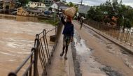 A boy carries vegetables in a flooded area, as Cyclone Batsirai sweeps inland, in Fianarantsoa, Madagascar, February 6, 2022. REUTERS/Alkis Konstantinidis

