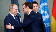 FILE PHOTO: Russian President Vladimir Putin shakes hands with French President Emmanuel Macron during the Libya summit in Berlin, Germany, January 19, 2020. REUTERS/Hannibal Hanschke