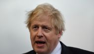 FILE PHOTO: Britain's Prime Minister Boris Johnson speaks with members of the media during a visit to Warszawska Brygada Pancerna military base near Warsaw, Poland February 10, 2022. Daniel Leal/Pool via REUTERS/File Photo
