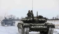 Russian servicemen drive tanks during military exercises in the Leningrad Region, Russia, in this handout picture released February 14, 2022. Russian Defence Ministry/Handout via REUTERS