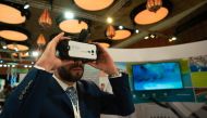 A summit delegate exploring a virtual reality (VR) device at the WISH 2018 Innovation Hub.