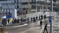 People queue at a coronavirus disease (COVID-19) tests tent at the Stadtspital Triemli hospital in Zurich, Switzerland January 13, 2022. REUTERS/Arnd Wiegmann