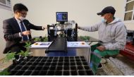 Officials with the automated grafting machine. 