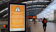 A person walks past a sign at Waterloo station, as a red weather warning was issued due to Storm Eunice, in London, Britain, February 18, 2022. REUTERS/May James
