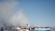 Smoke rises from the Italian-flagged Euroferry Olympia, which sailed from Greece to Italy early on Friday and caught fire, off the coast of Corfu, Greece, February 19, 2022. Reuters/Guglielmo Mangiapane